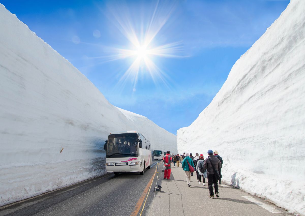 Schneewand auf der Tateyama-Kurobe-Alpenroute vor blauem Himmel